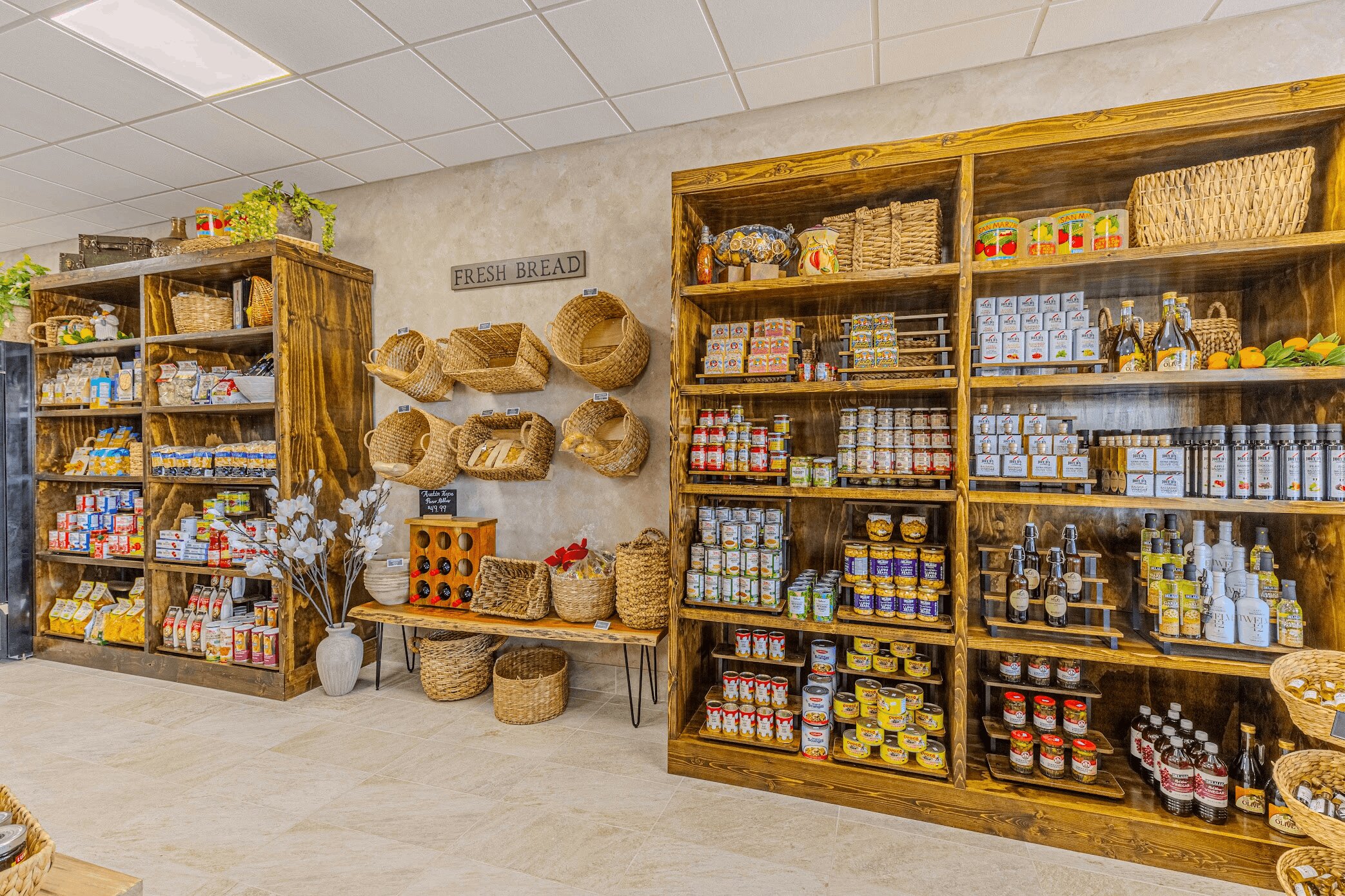 Wooden shelves stocked with pantry goods, pasta, and wicker baskets