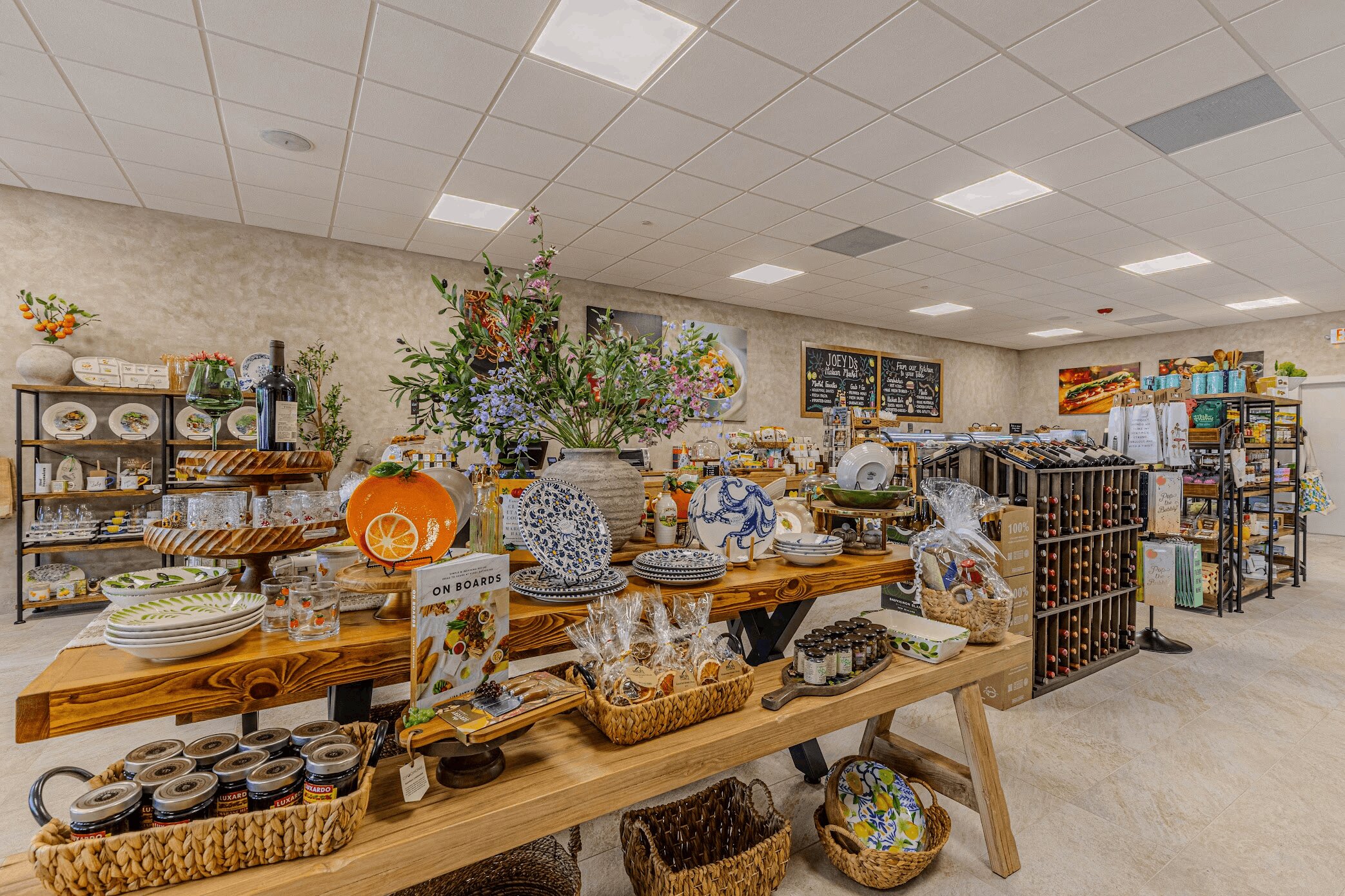 Rustic table display of ceramics, pottery, and gourmet products