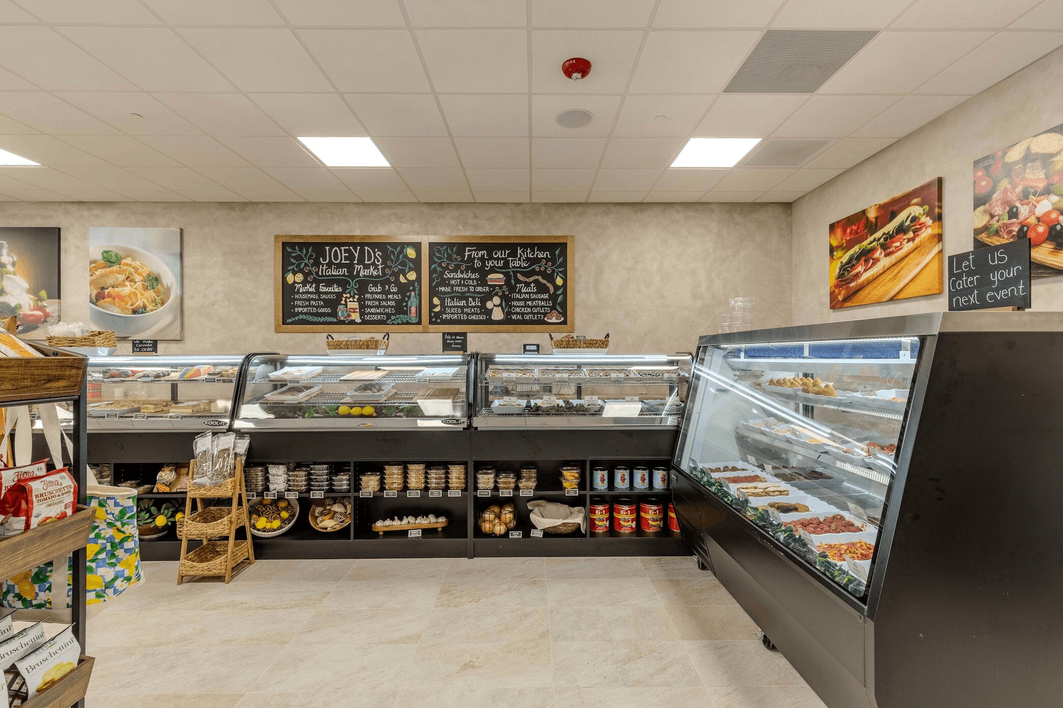 Glass deli cases with prepared foods and chalkboard menus overhead
