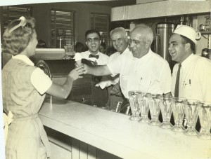 Albert, John, George, and Victor Doumar serve ice cream to waitress Inez Cuthrell in 1957
