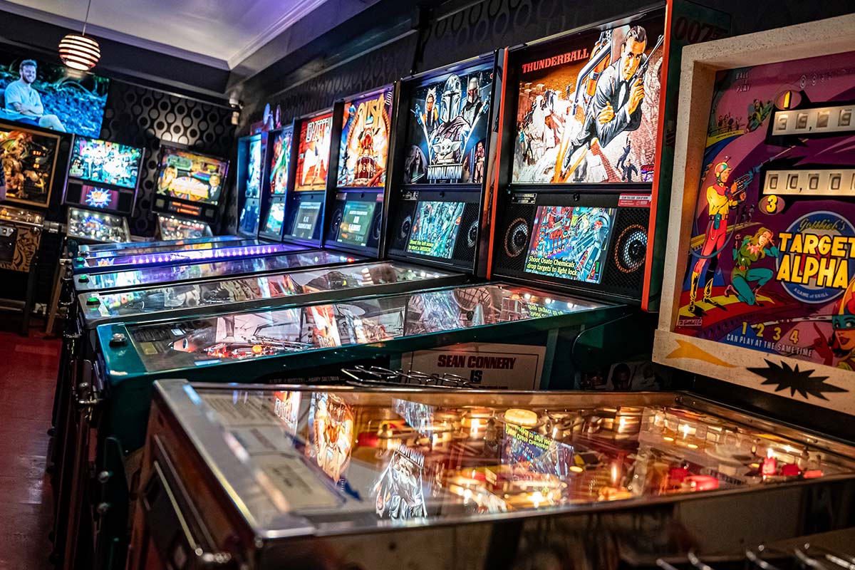 Pinball machines in a room with various games.