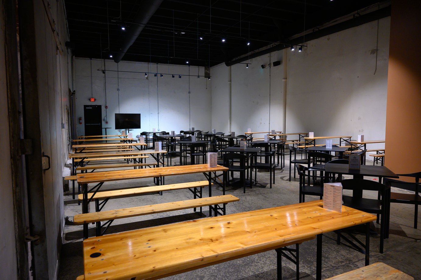 The west wing's open design room with tables and benches