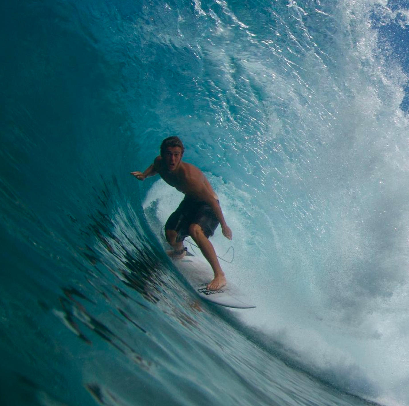Tex Mitchell surfing in a wave