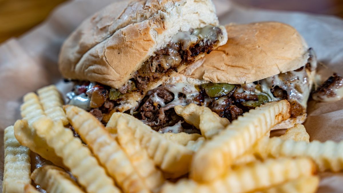 Philly cheese steak  and fries, close up