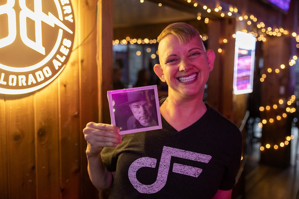 Girl holding a photo in a bar