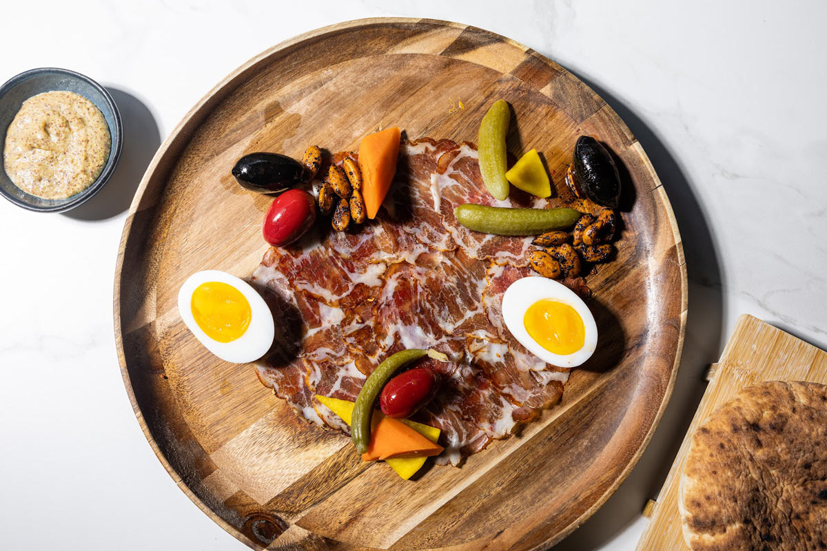 Charcuterie and Cheese board, with pickles, olives, nuts and soft-boiled eggs