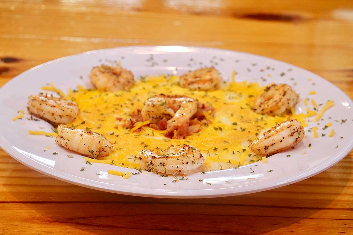 Shrimp and grits, topped with cheddar cheese