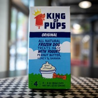 A carton of king of pups ice cream sitting on a table