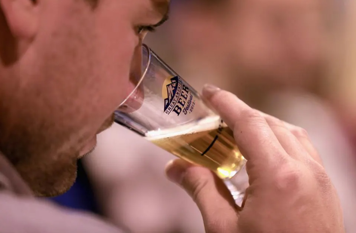 a man tasting a beer