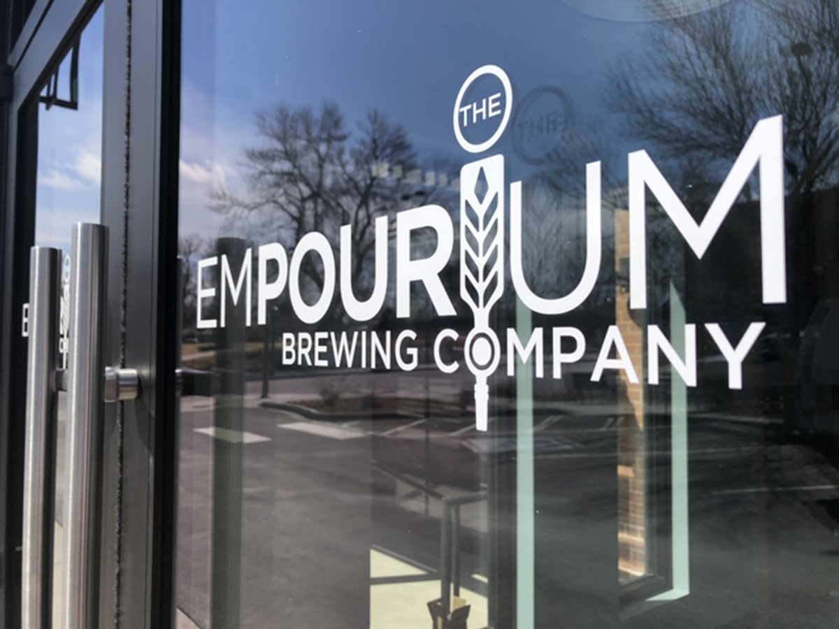 empourium brewery logo on a glass doors
