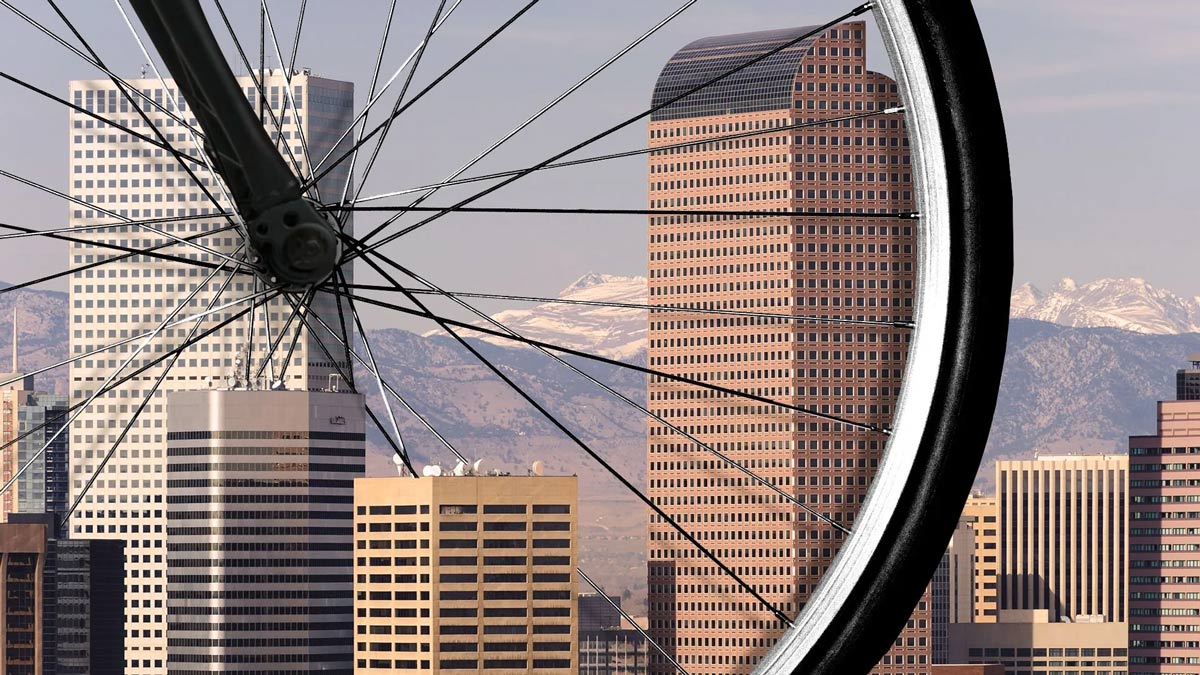 photo of a city white a bycile wheel at front