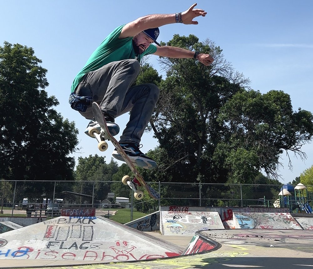 a skateboarder doing a trick at a skate park