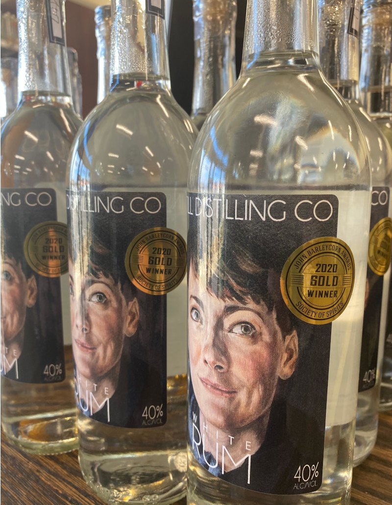 Three bottles of InStill Distilling Co White Rum with gold medal stickers