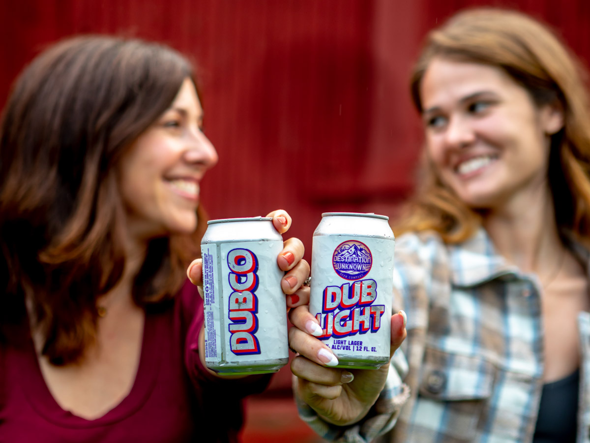 Two girls with cans of beer