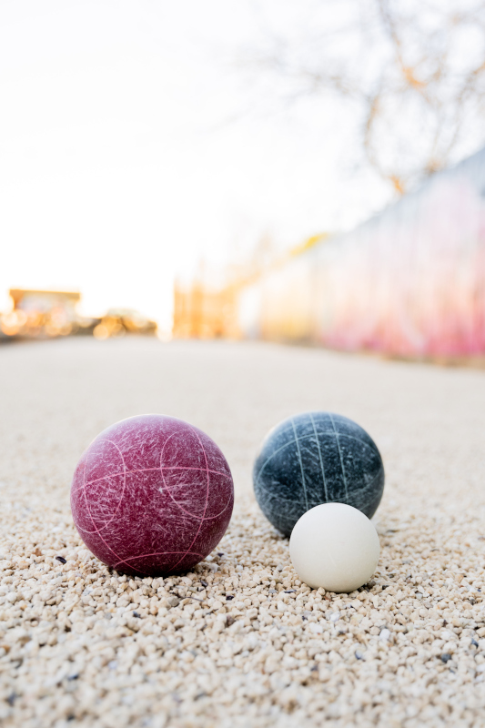 a group of balls on a gravel surface