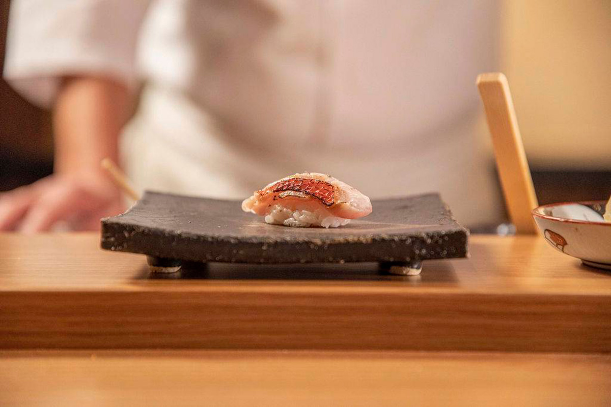 Sushi on a plate in a front of a chef