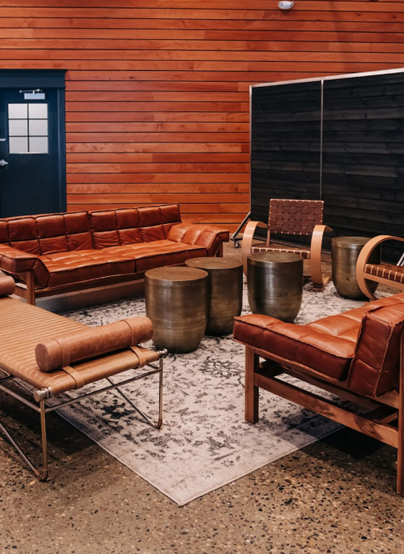 Modern lounge area with leather seating and wooden accents.