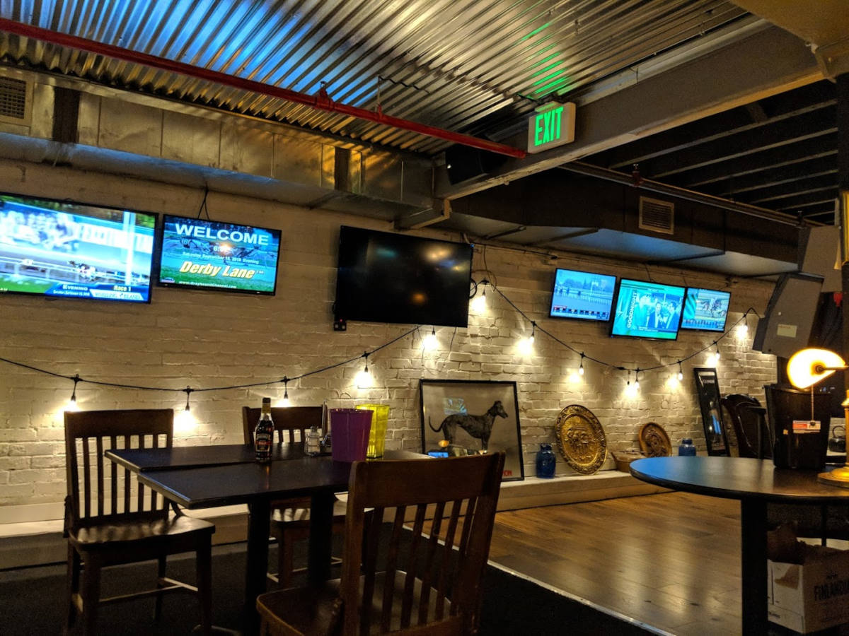 Interior, dining area, TV screens on the wall