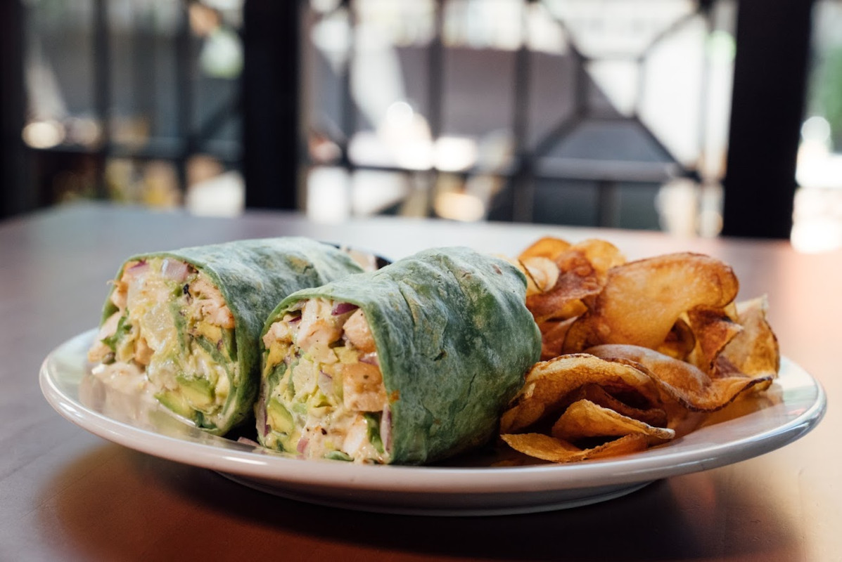 Two burritos, snacks on the side