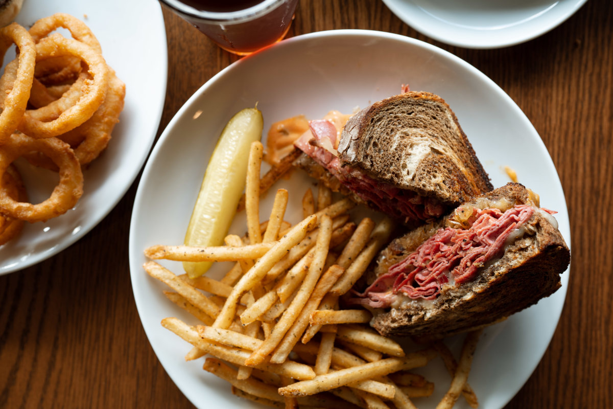Reuben sandwich with fries and pickle