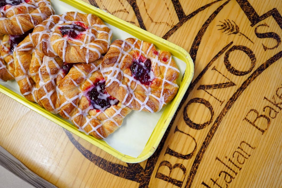 Danish pastry filled with fruit and covered with icing drizzle