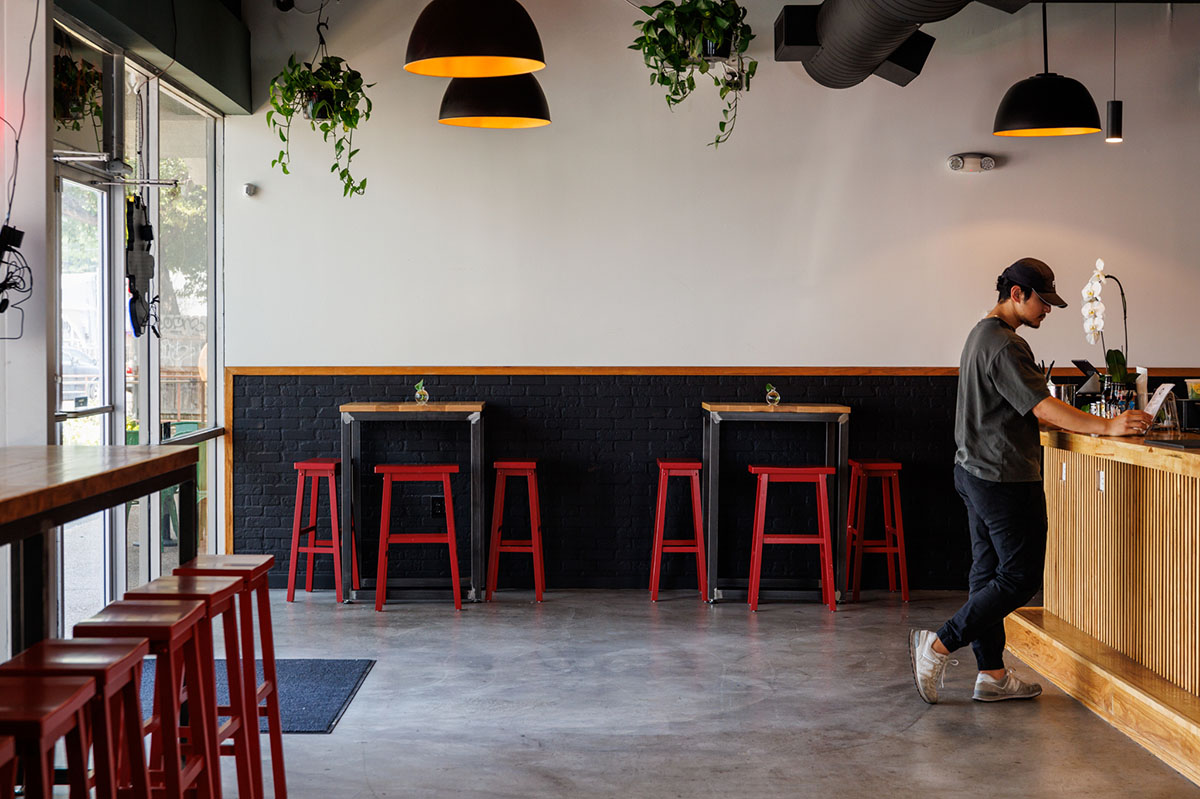 Interior, seating area, tables and bar stools by the wall