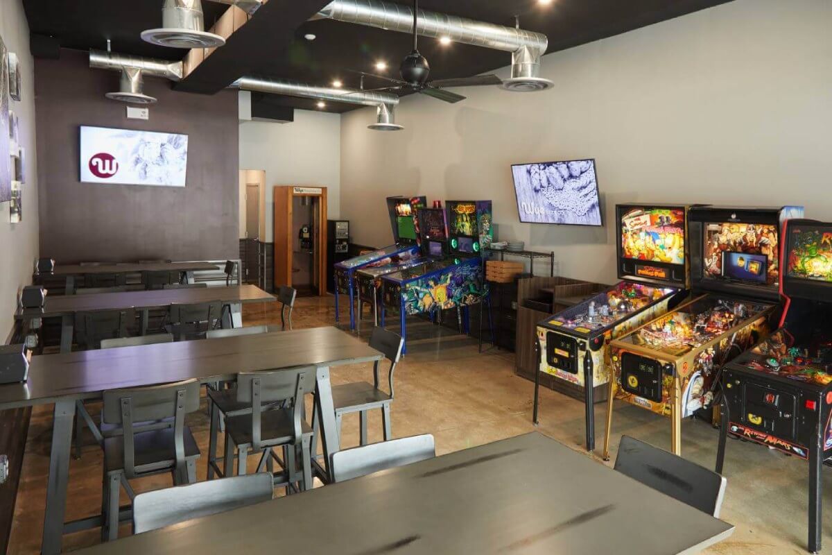 Restaurant interior with seating area and pinball machines