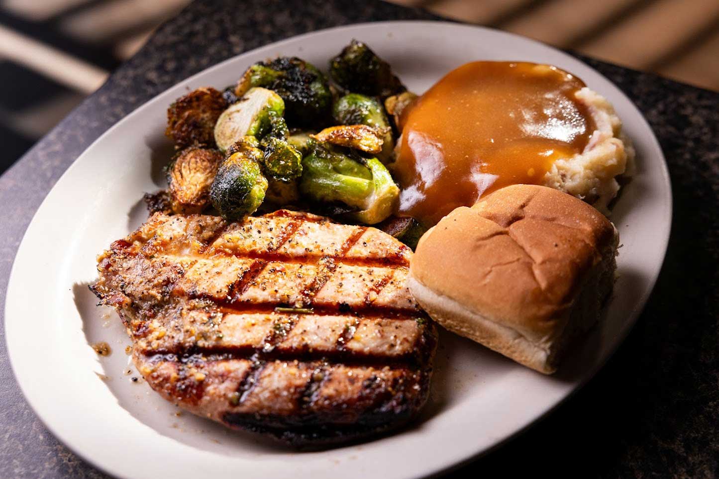 Pork chops  brussel sprouts, and mashed potatoes and gravy 