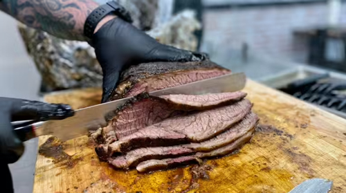 Chef is cuting smoked meat