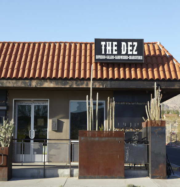 A red golf cart is parked in front of the Dez store