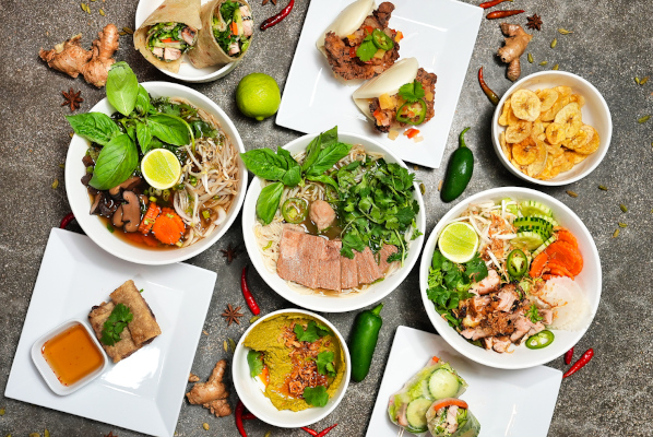 A variety of vietnamese food in bowls on a table