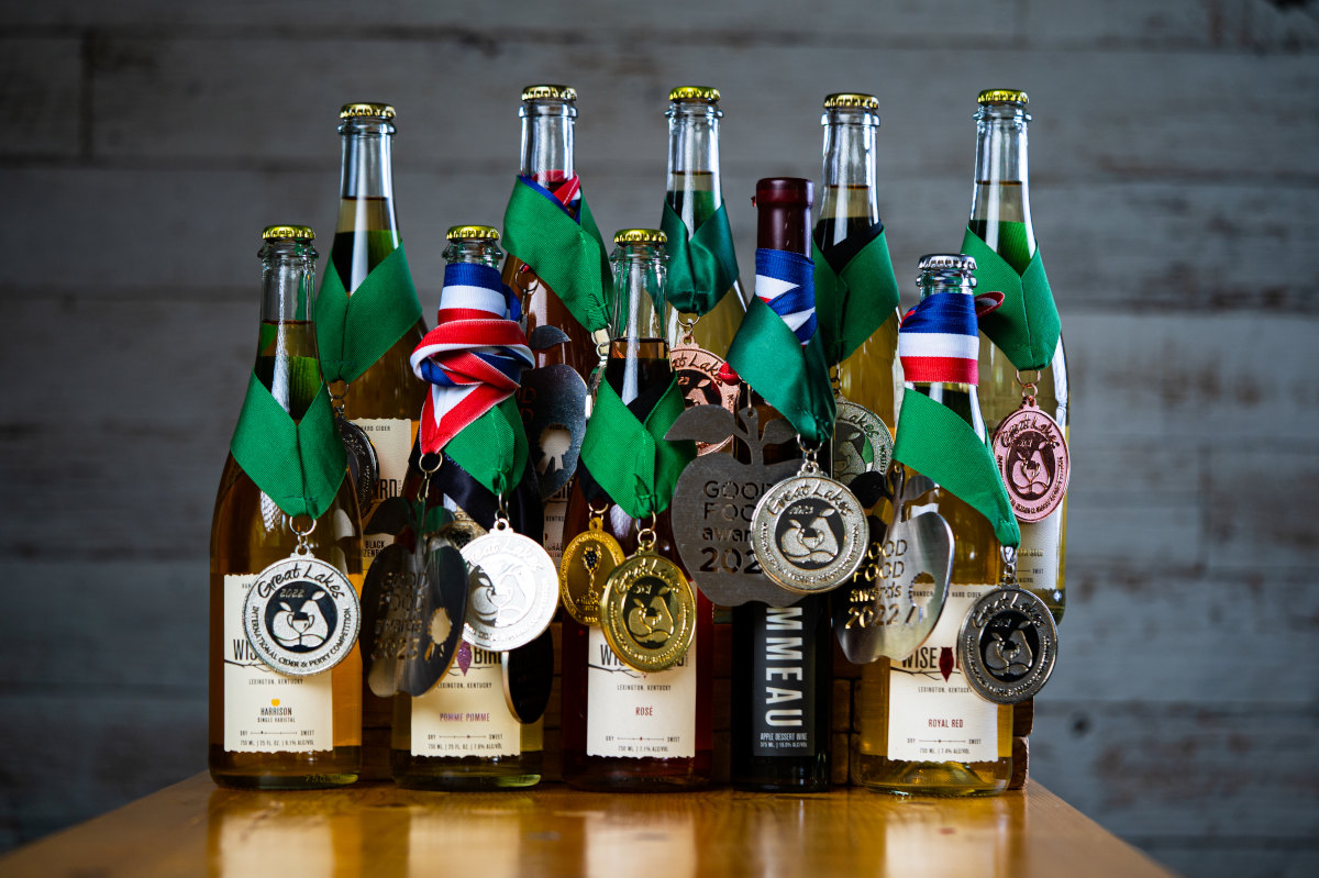 A collection of wine bottles adorned with medals, showcasing their excellence.