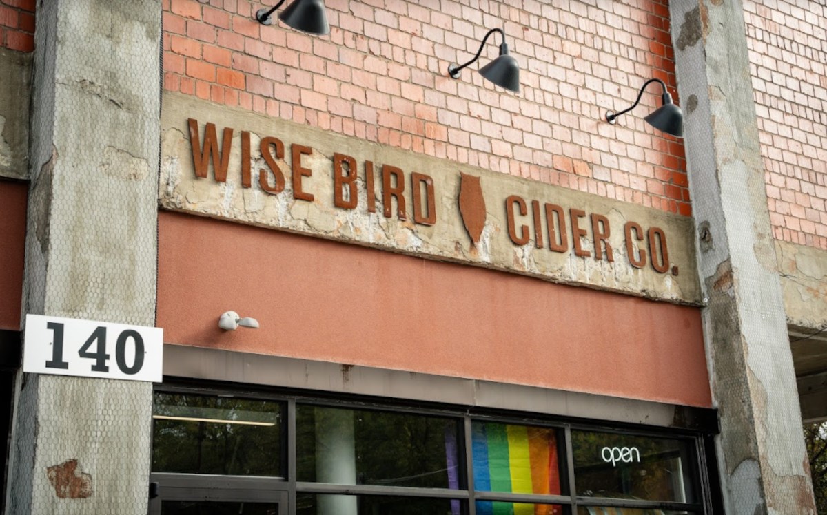 Exterior of Wise Bird Cider Co. building with prominent sign displaying the company's name.