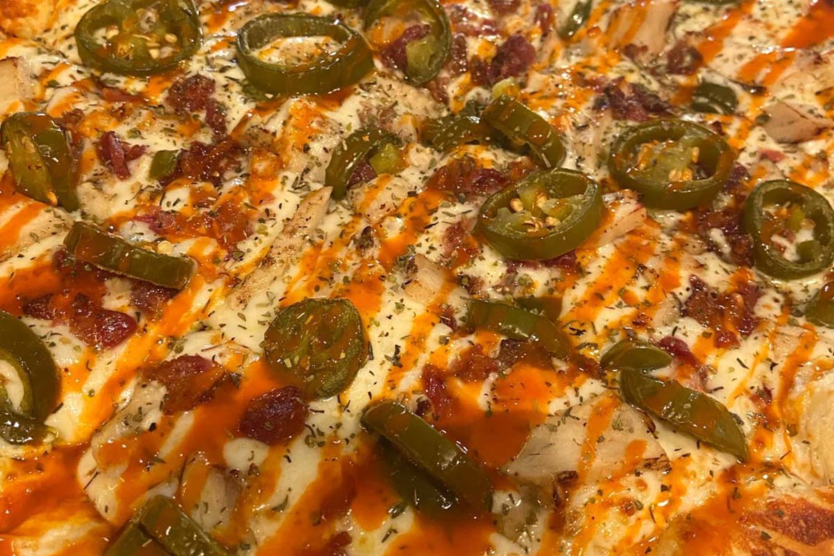 Buffalo chicken pizza, with cheese, ranch sauce, chicken, and jalapenos