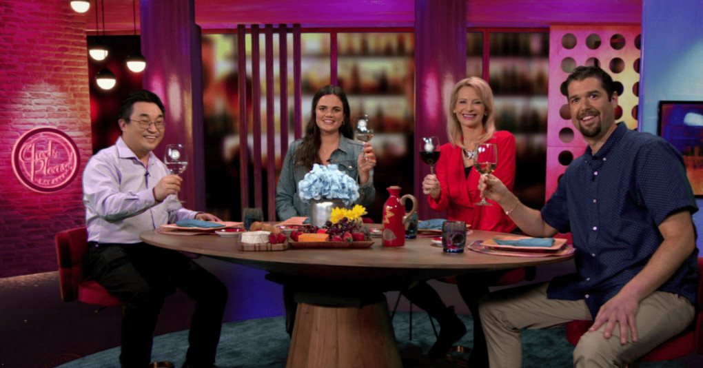 Hosts and guests sitting in studio.