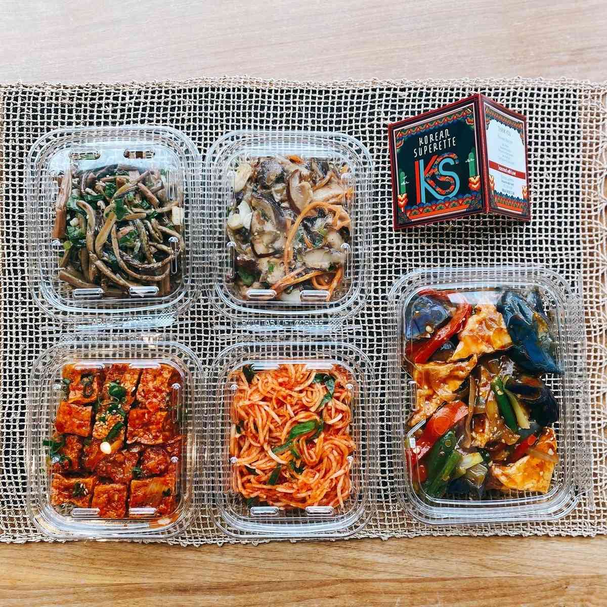 Assorted food in plastic containers on a table.