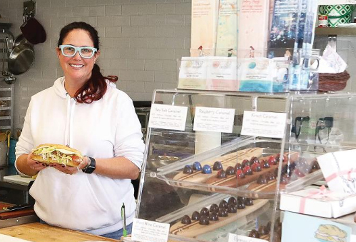 Solange Corner, owner of Cultured Slice Sandwich Shop, holds one of her creations