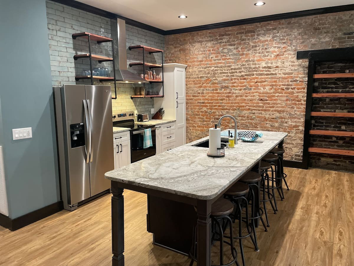 Kitchen area, fridge, shelves, and a kitchen table