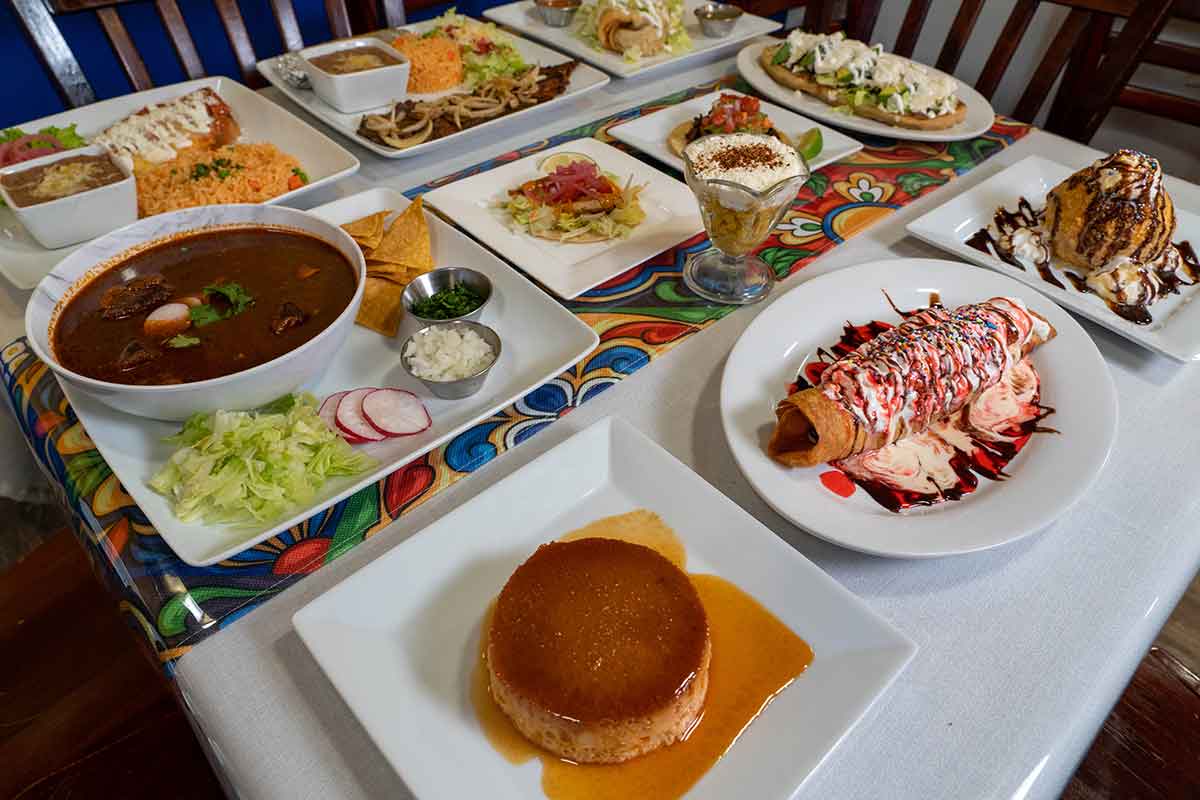 assortment of mexican dishes spread on the table
