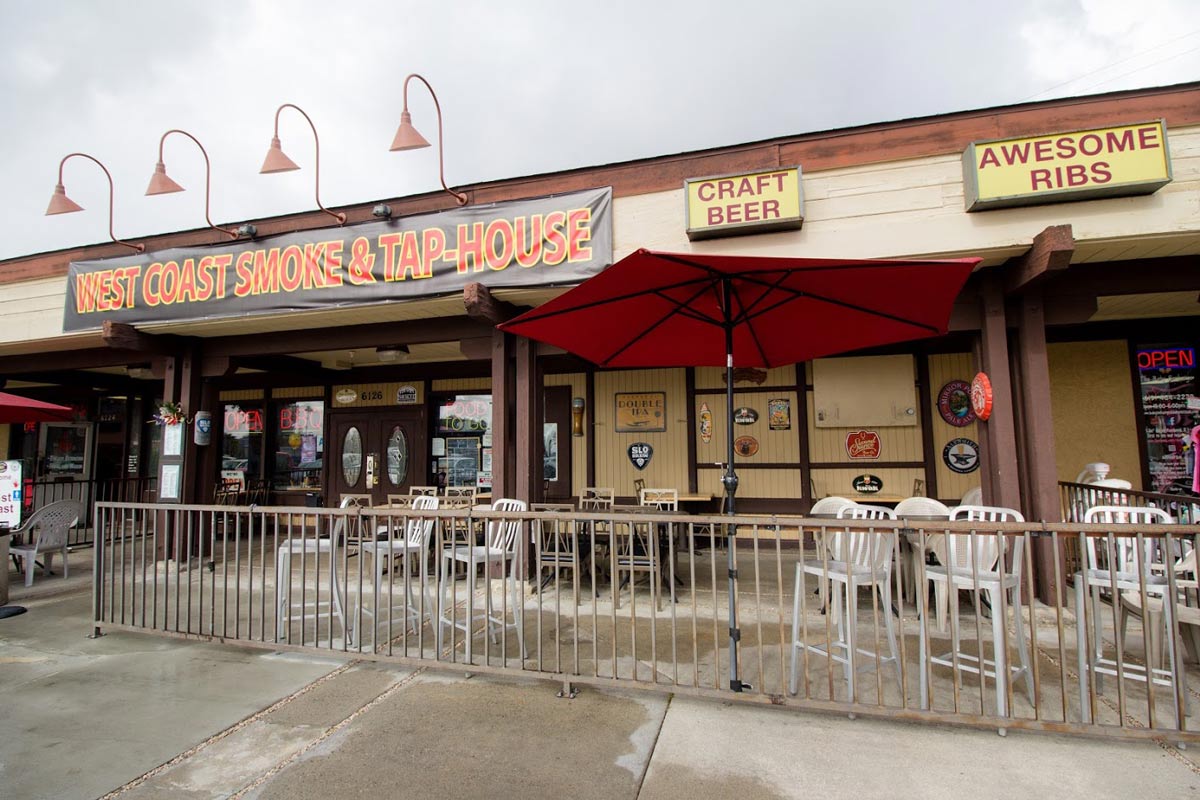 Exterior of West Coast Smoke and Tap House with outdoor seating