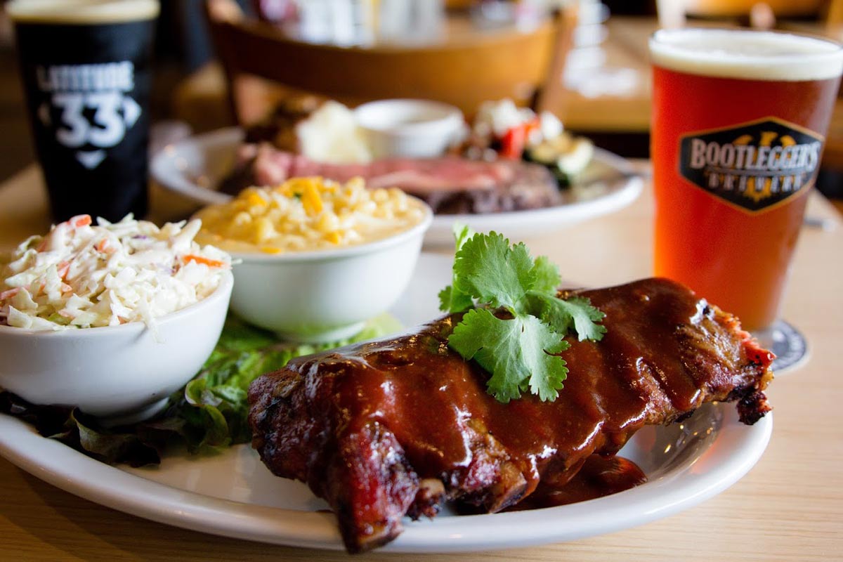 Barbecue ribs with sides and two glasses of beer