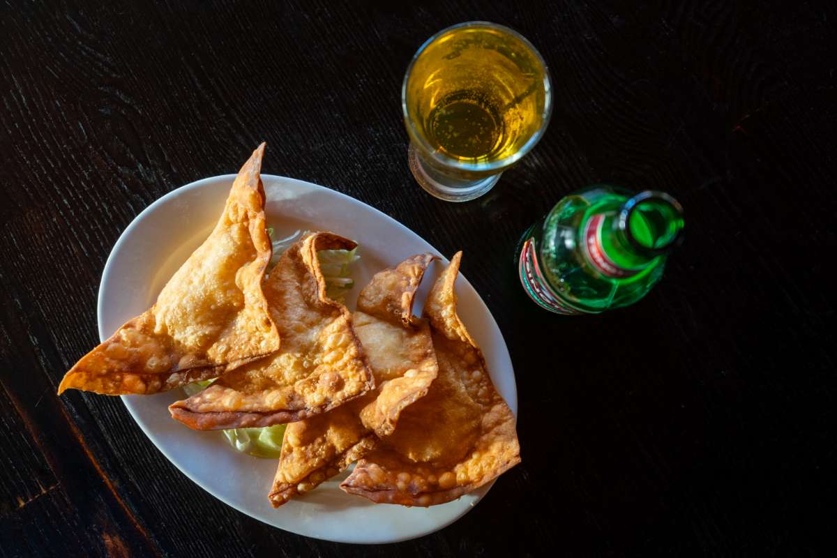 Crab Rangoon appetizer with a glass of beer
