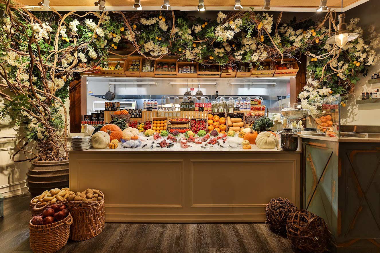 Interior, a counter with fruits and vegetables displayed, flower arrangements