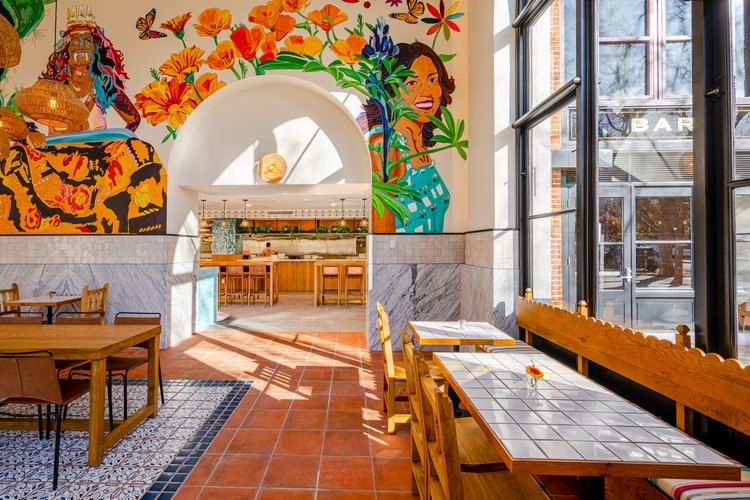 Restaurant interior side view with mural on the wall
