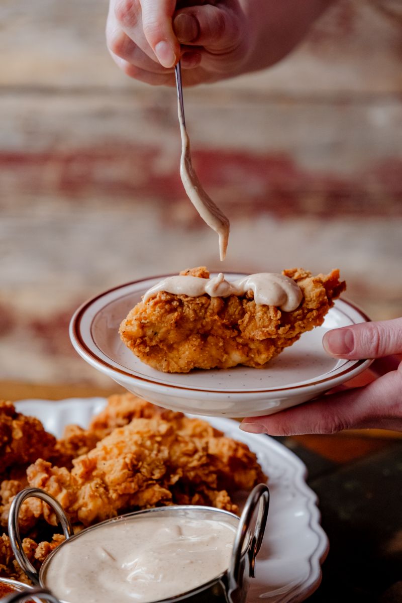Sauce drizzled over a crispy fried chicken tender