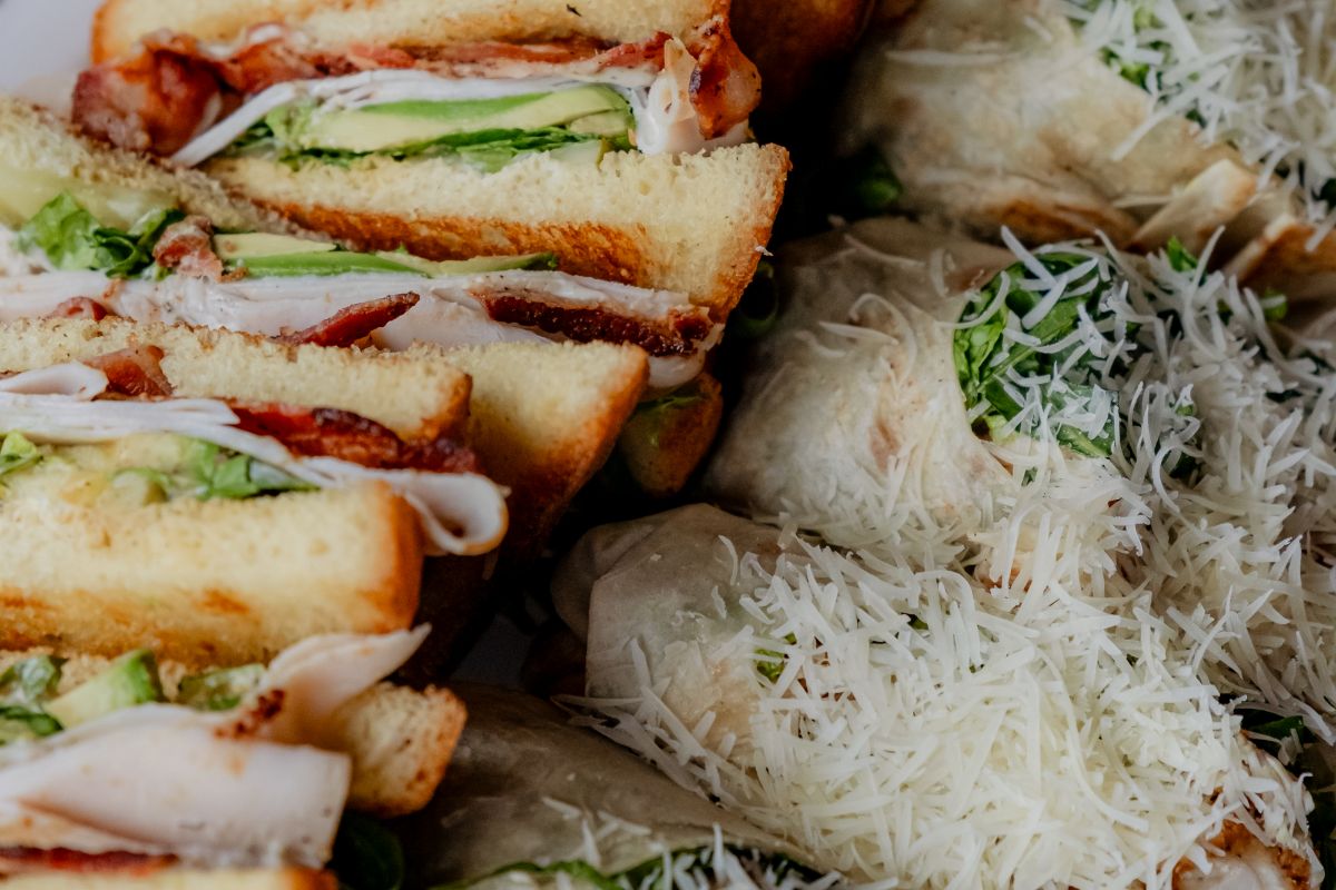 Club sandwiches and wraps topped with shredded parmesan
