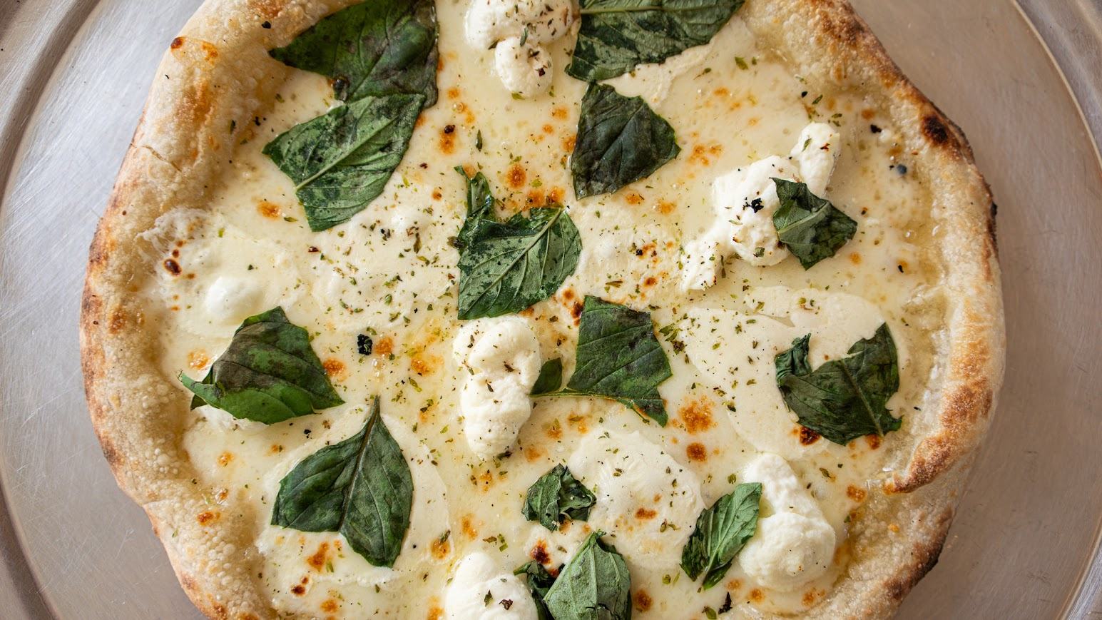 Pizza with Garlic, parmesan cheese, organic Sicilian oregano, fresh basil, and fresh mozzarella.
