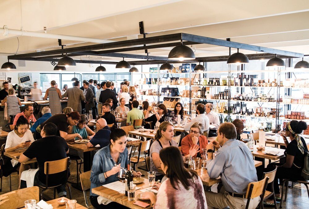 A crowded dining establishment where guests are engaged in eating and drinking