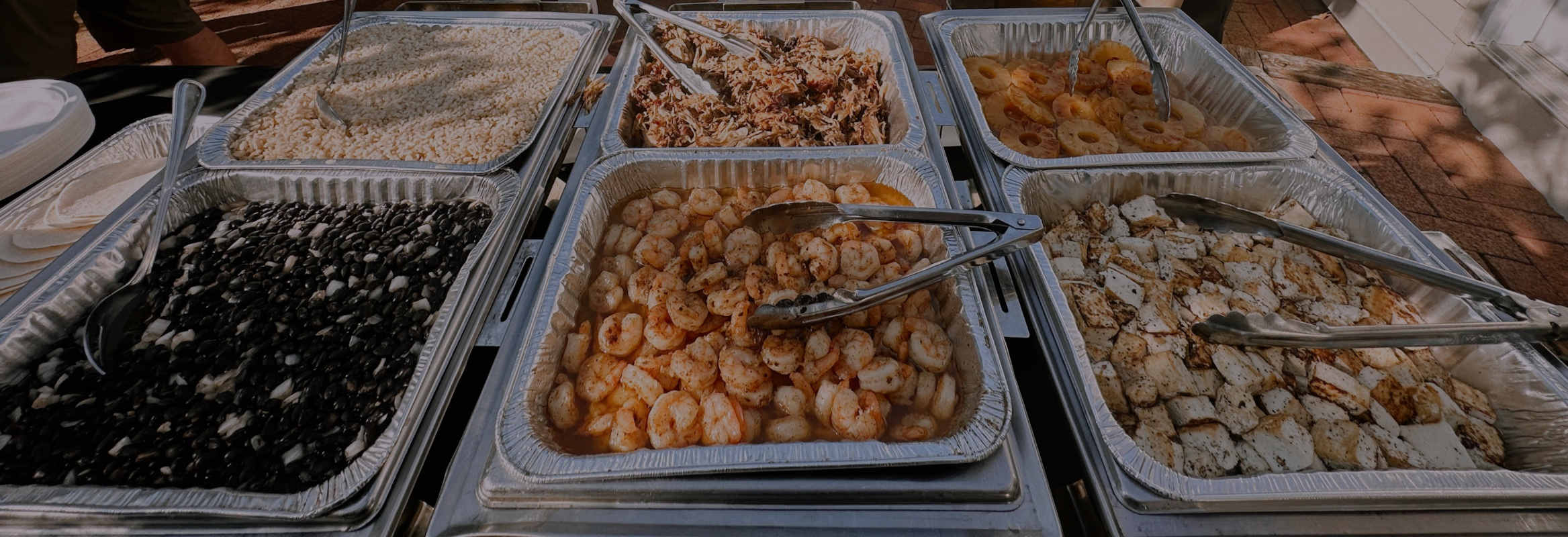 Trays of food with tongs