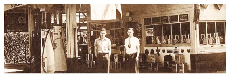 Vintage photo showing two people in front of the cafe